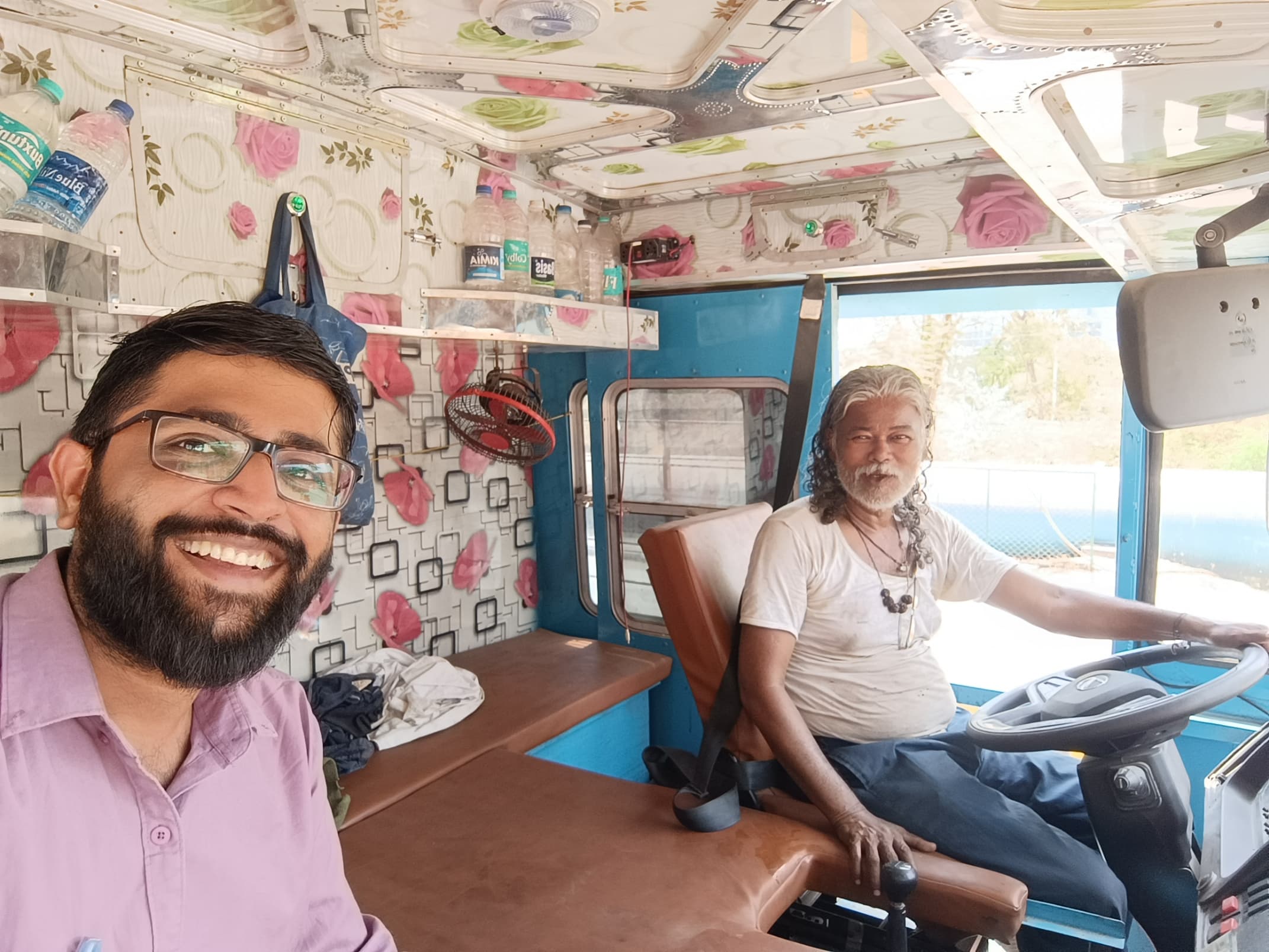 With drivers beside their trucks